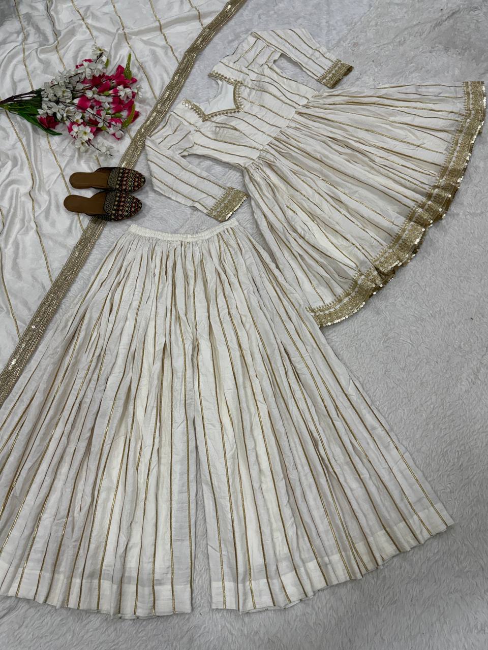 Radiant Rose Pink Flared Peplum Kurti and Sharara Set Embellished with Luminous Gold Zari Stripes and Sequined Borders